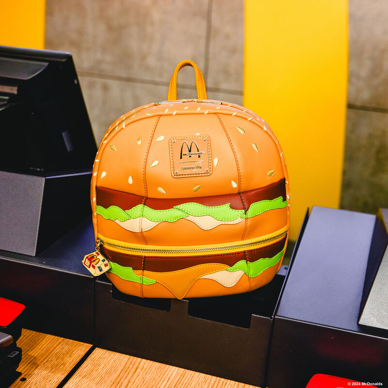 Loungefly McDonald's Big Mac Figural Mini Backpack sitting next to a cash register at a McDonald's restaurant